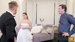 Bride4K video preview features a seductive brunette in a white dress, hinting at a steamy cuckold-themed wedding night.
