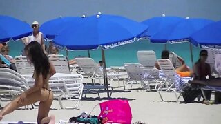 Nikki Brazil, a stunning exhibitionist wife, flaunts her curves in a micro thong at the beach, indulging in public nudity and flashing. Sex video.